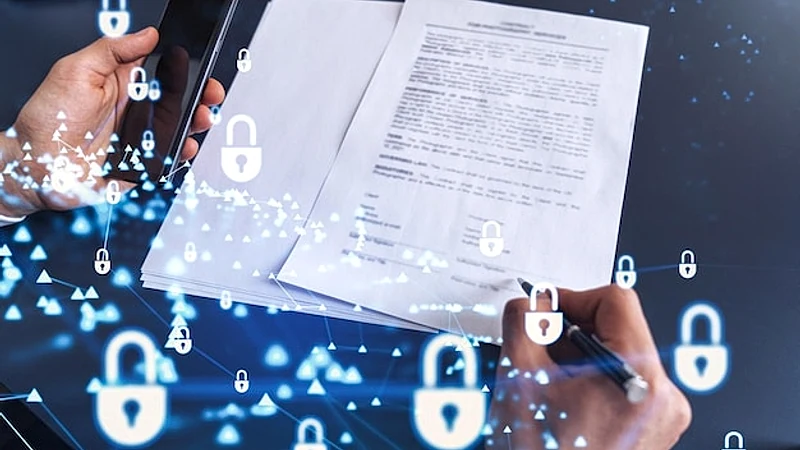A businessman in formal wear signing the contract to prevent probability of risks in cyber security Padlock Hologram icons over the working desk