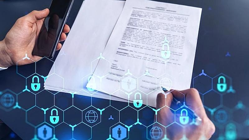 A businessman in formal wear signing the contract to prevent probability of risks in cyber security Padlock Hologram icons over the working desk