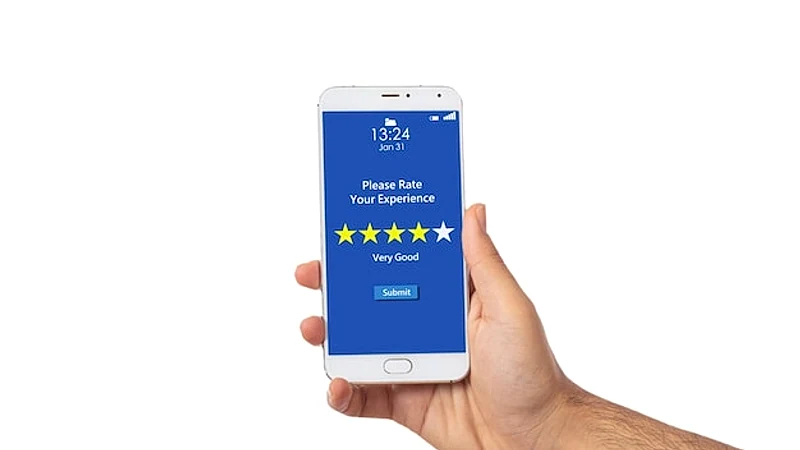 Man hand holding a smartphone 4 stars very good text on the screen isolated on white background