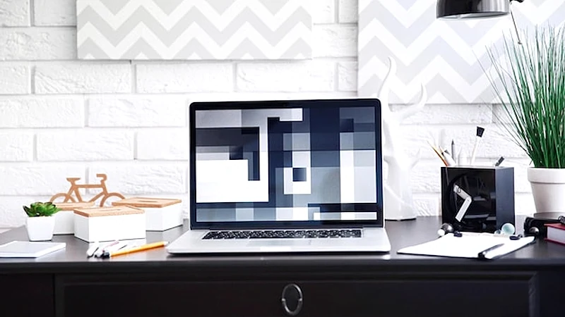 Workplace with laptop on table at home