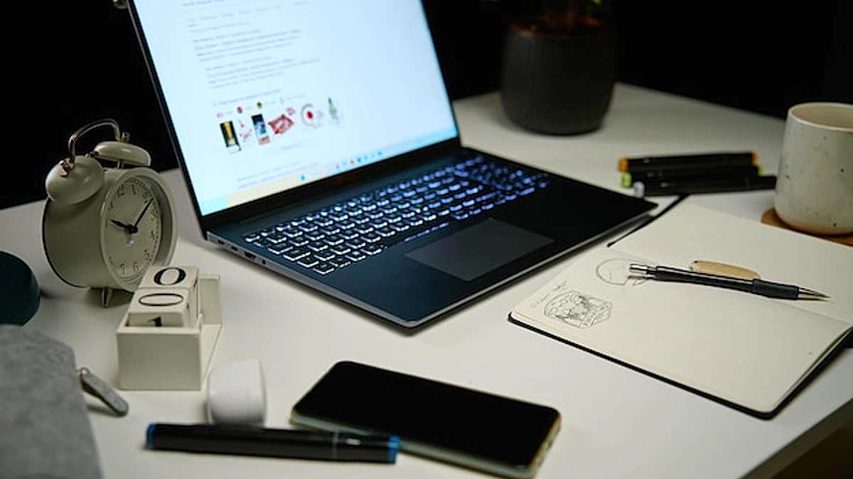Home office workplace without people at night laptop on table in living room