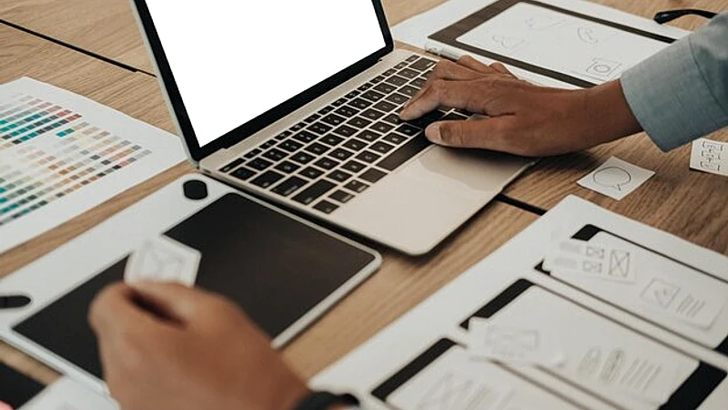 Midsection of design professional working on table