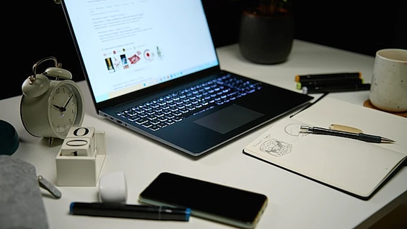Home office workplace without people at night laptop on table in living room