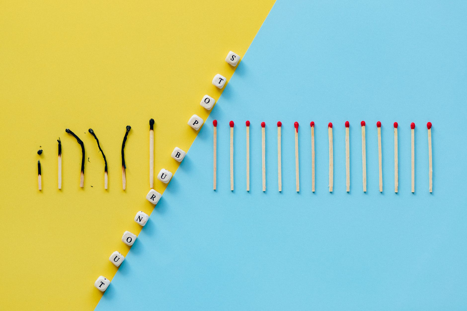 Illustration of burnout concept with burned matches and letter cubes spelling 'Stop Burnout.'