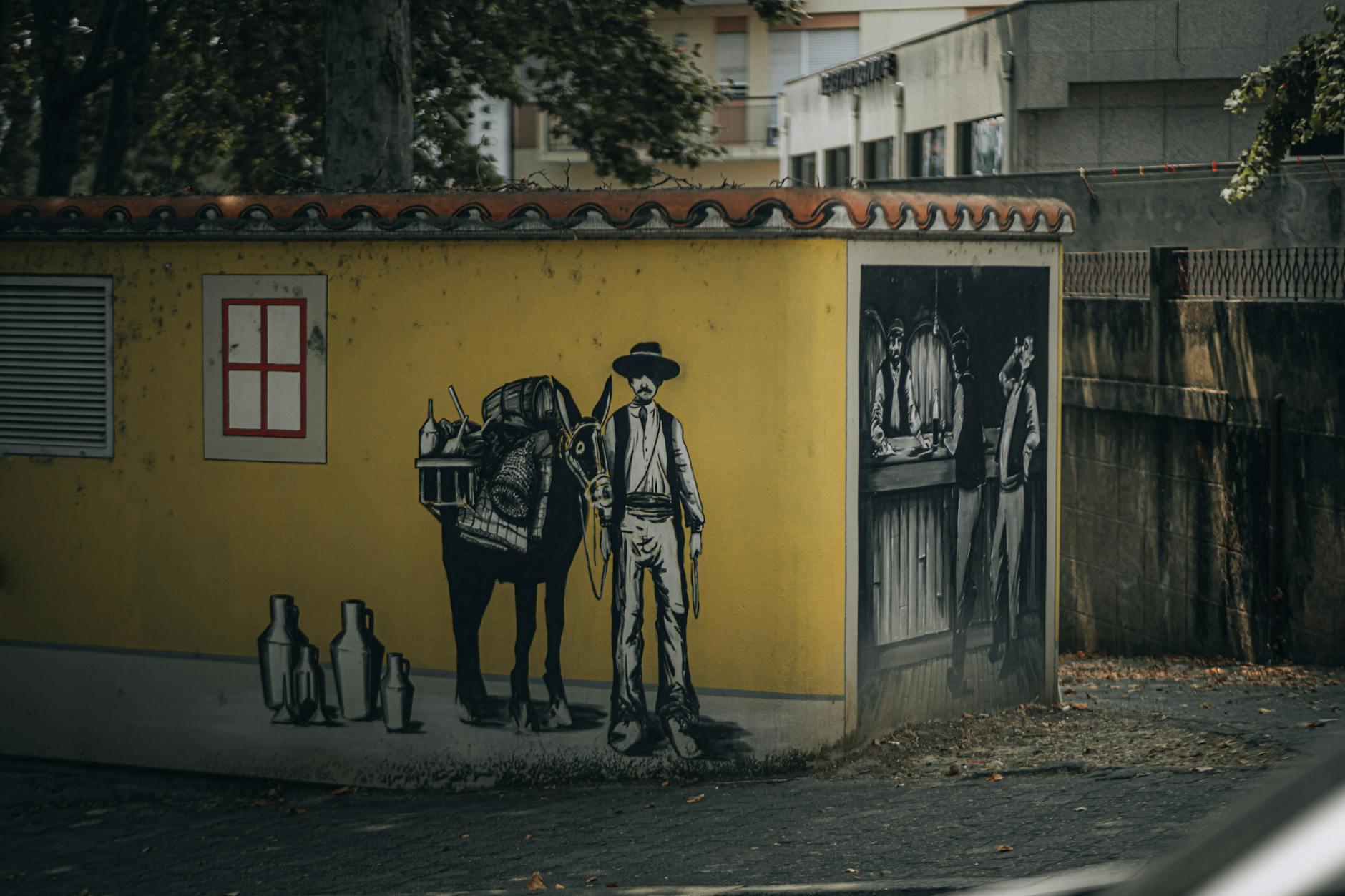 Outdoor mural of a cowboy with a donkey and a saloon scene, showcasing urban art style.
