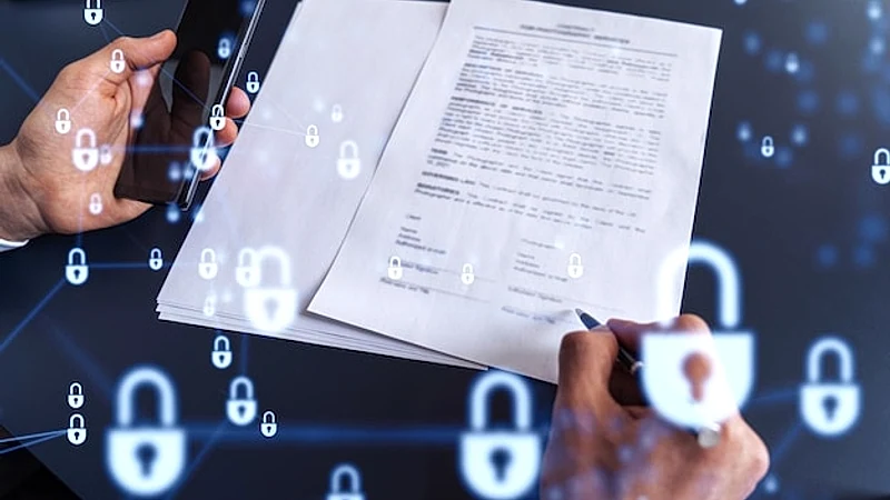 A businessman in formal wear signing the contract to prevent probability of risks in cyber security Padlock Hologram icons over the working desk