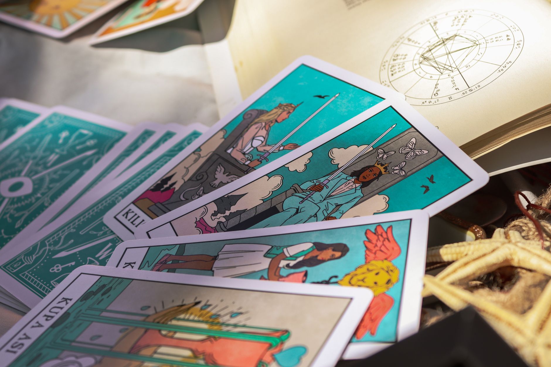 Close-up of vibrant tarot cards and an astrological chart, evoking mystery and fortune-reading themes.