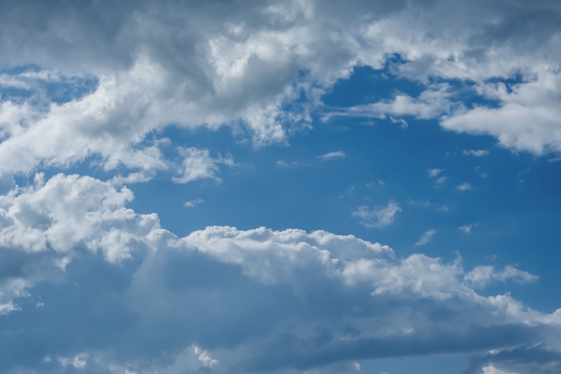 Vibrant blue sky with white clouds over Freiburg, Germany, showcasing natural beauty.