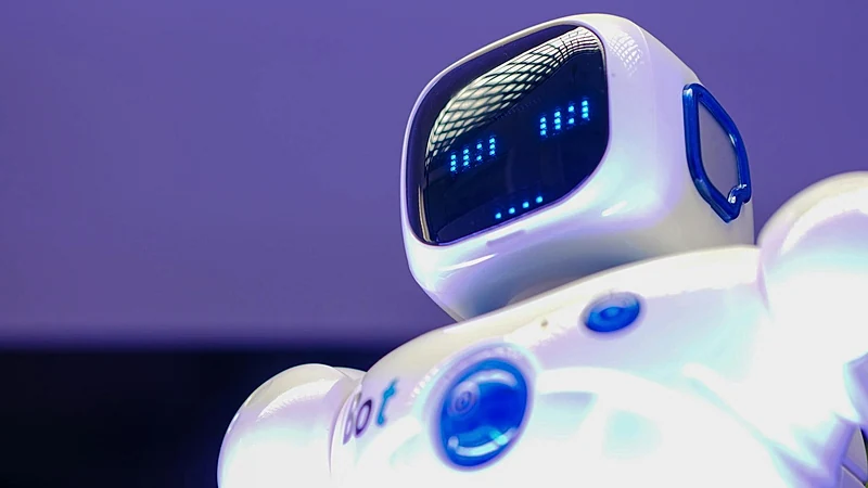 A modern humanoid robot with digital face and luminescent screen, symbolizing innovation in technology.