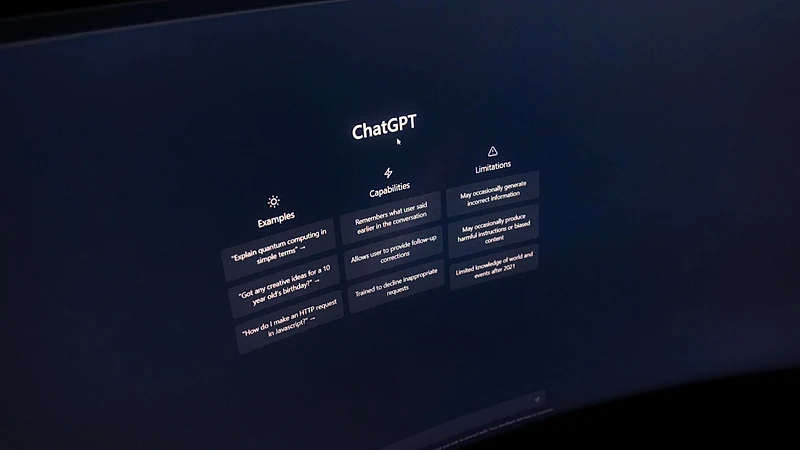 Close-up of a computer screen displaying ChatGPT interface in a dark setting.
