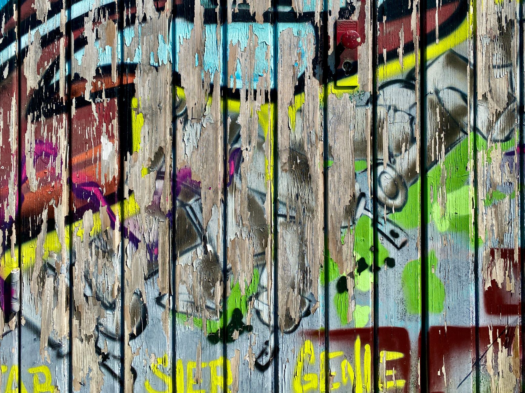 Bright graffiti art on a decaying wooden wall in Vaihingen an der Enz, Germany.