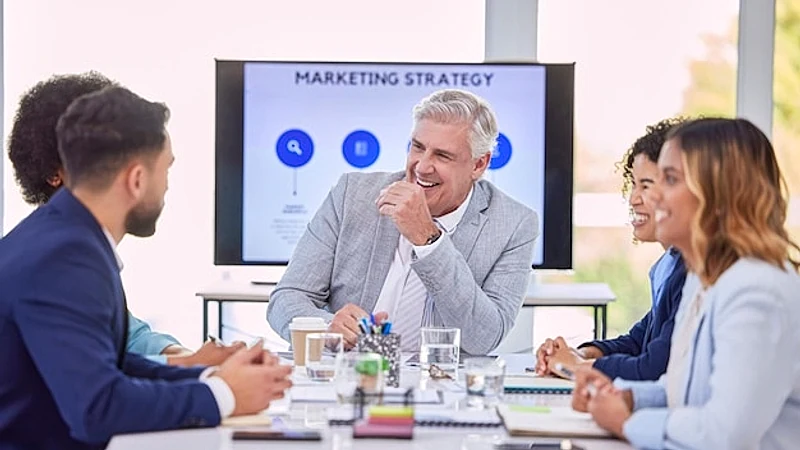 Business people meeting and marketing team laughing for funny meme joke or collaboration at office Corporate CEO man laugh with employees in conference room for fun strategy or teamwork planning