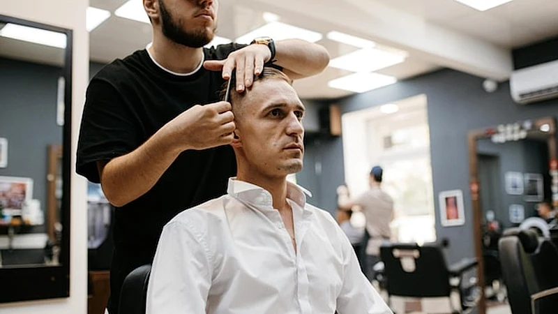 portrait of a young guy groom at the training camp in the barbershop