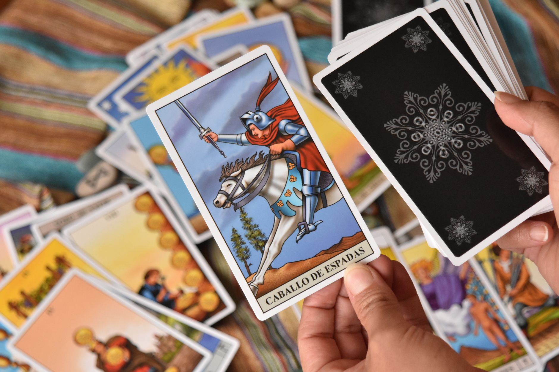 A close-up view of a Tarot card reading session with intricate designs and vibrant colors.